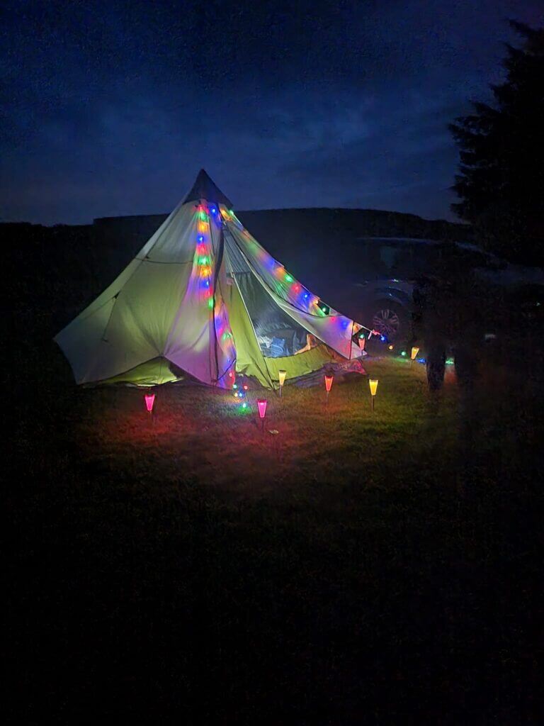 Brightly lit tent with multi coloured lights
